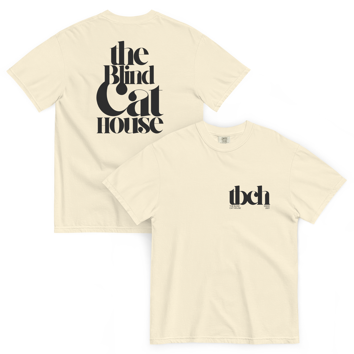 Ivory short sleeve t-shirt shown front and back on a white background. The back features large black typography reading "The Blind Cat House" in a bold, vintage-style font The front has a small black chest logo reading "tbch" with the blind cay house" and "since 2021" beneath it
