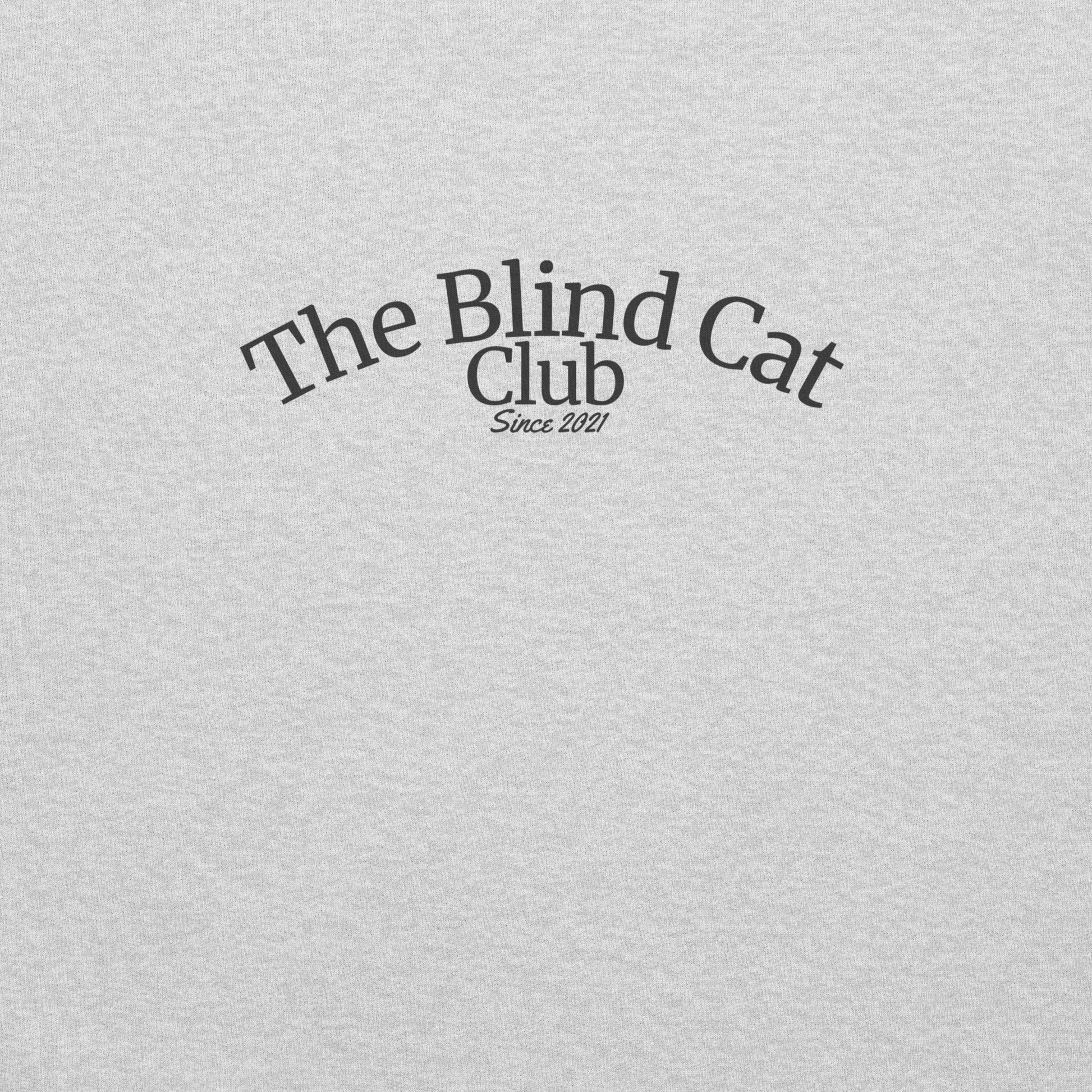 Text 'The Blind Cat Club Since 2021' on a fabric textured gray background